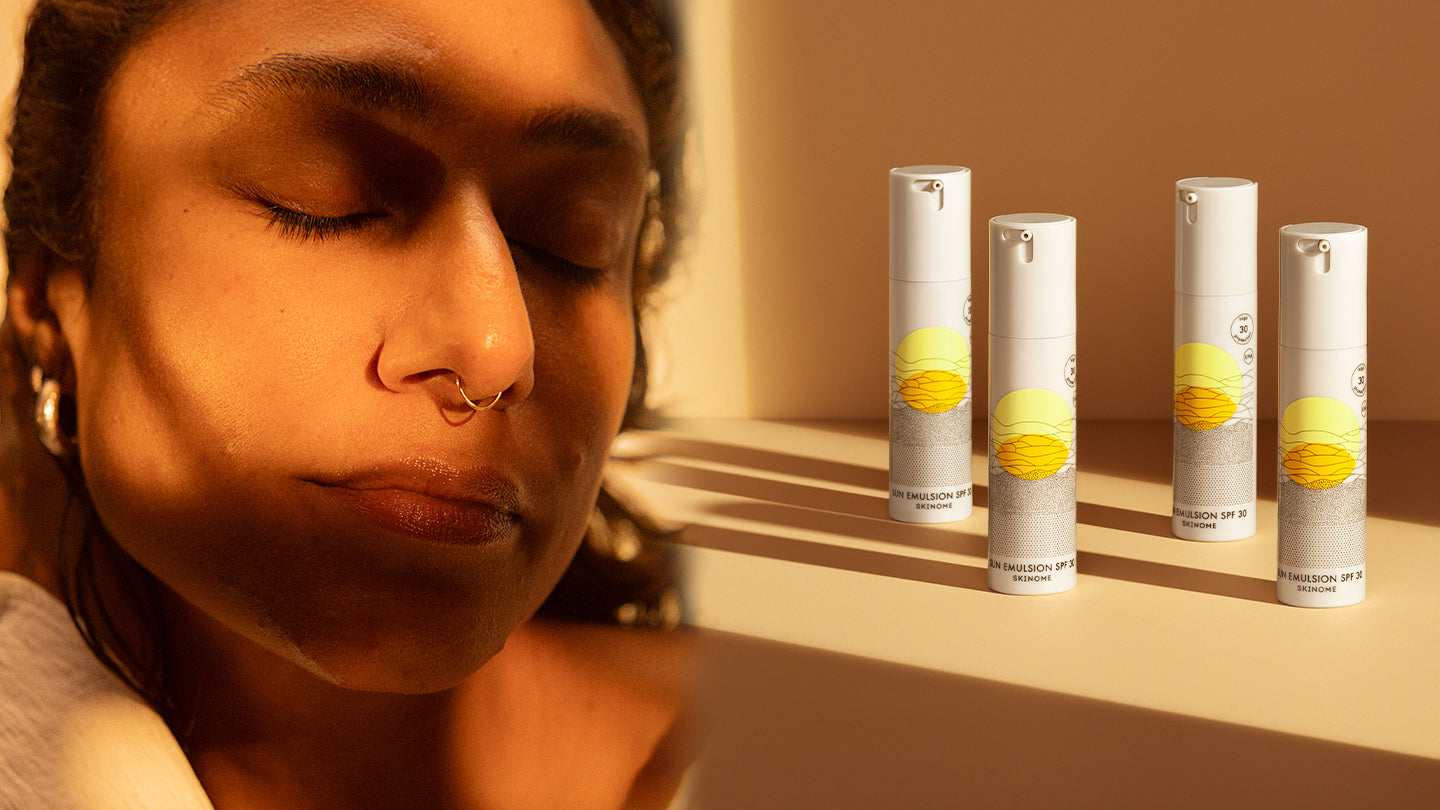 Person i solljus med hatt och solskydd, symboliserar balans mellan D-vitamin och skydd mot UV-strålning